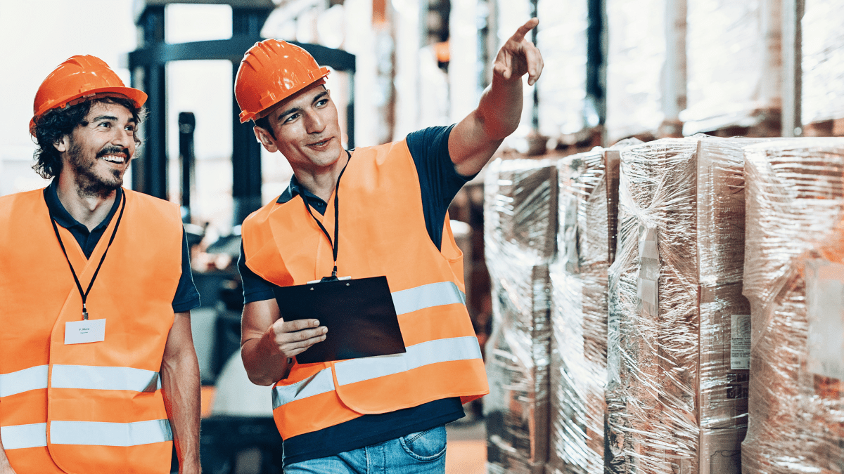 Suppliers walking and talking in a warehouse